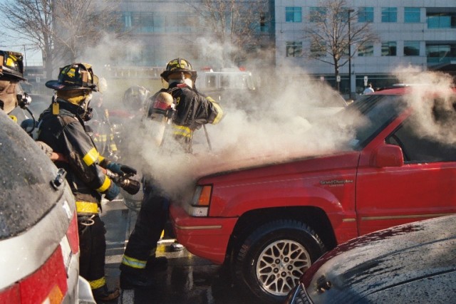 Crews force open a hood at a car fire, 99 Wood Avenue South on March 21, 2005.